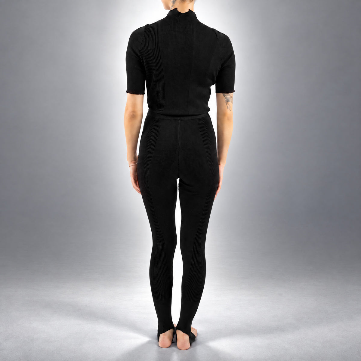 STANDISH. Jodi Tight in Carbon Black, a knit tight, worn, back view #color_carbon black
