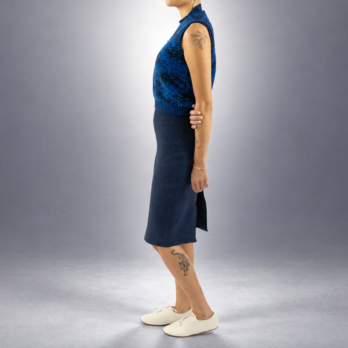 STANDISH. Paula Vest in Lapping Blue/Midnight Navy Jacquard, a knit vest, worn, side view #color_lapping blue/midnight navy jacquard