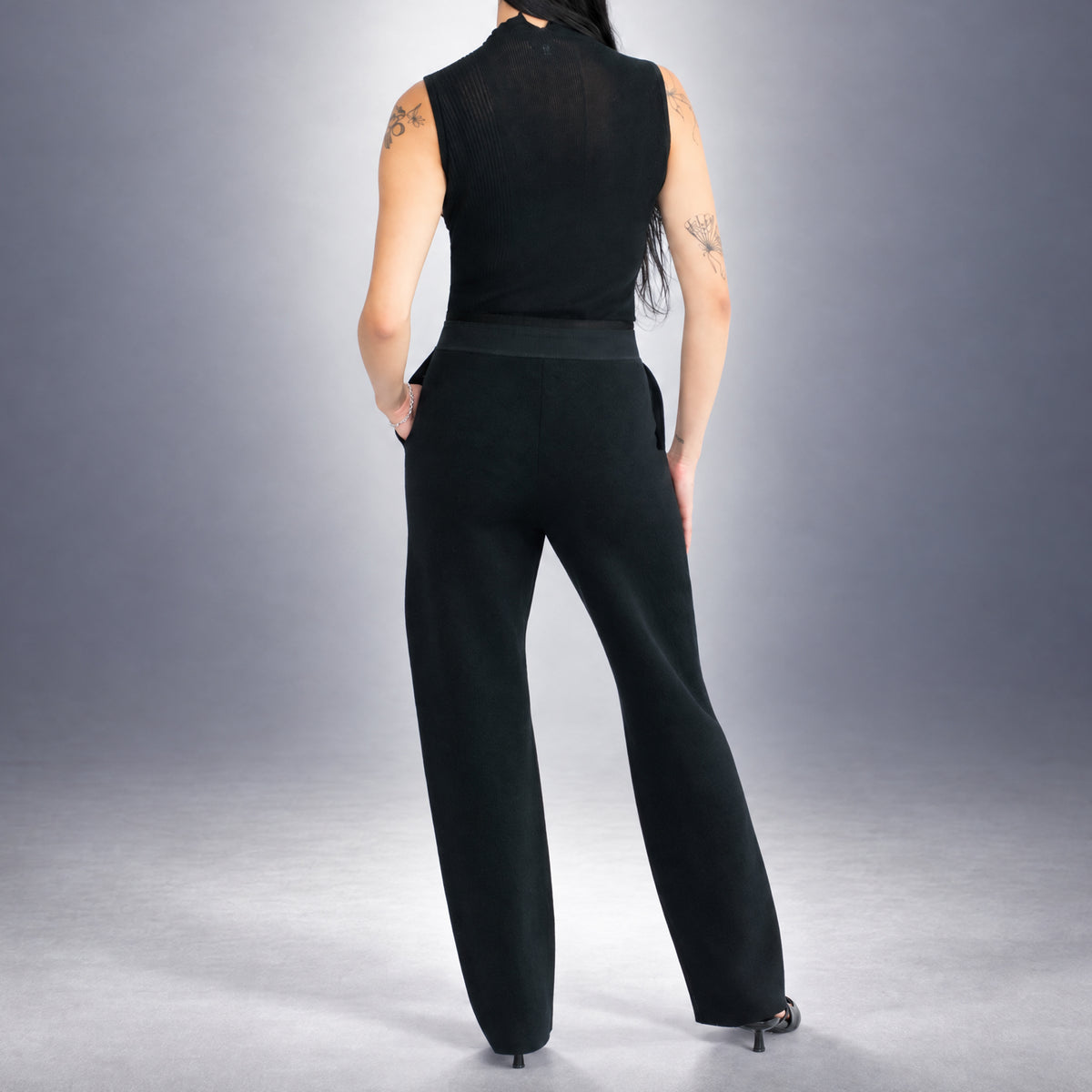 STANDISH. Suzy Track Pant in Carbon Black, a knit track pant, worn, back view #color_carbon black