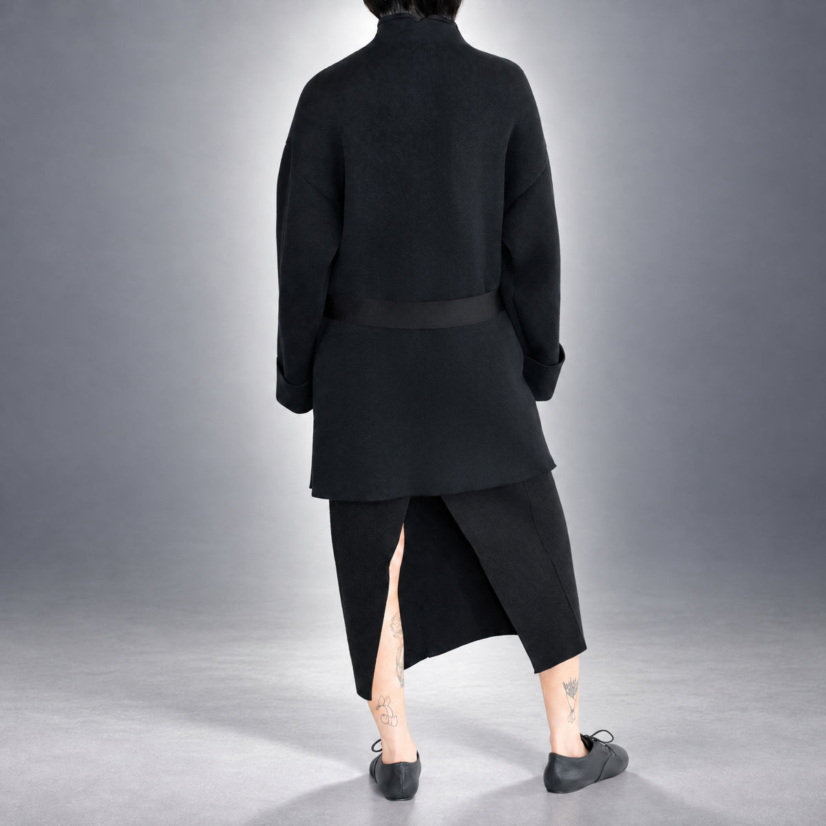 STANDISH. Jessica Coat in Carbon Black, a knit coat, worn, back view #color_carbon black