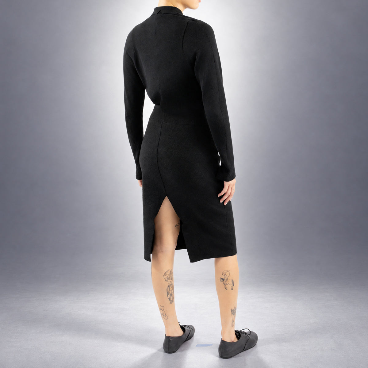 STANDISH. Mickey Skirt in Carbon Black, a knit skirt, worn, back view #color_carbon black