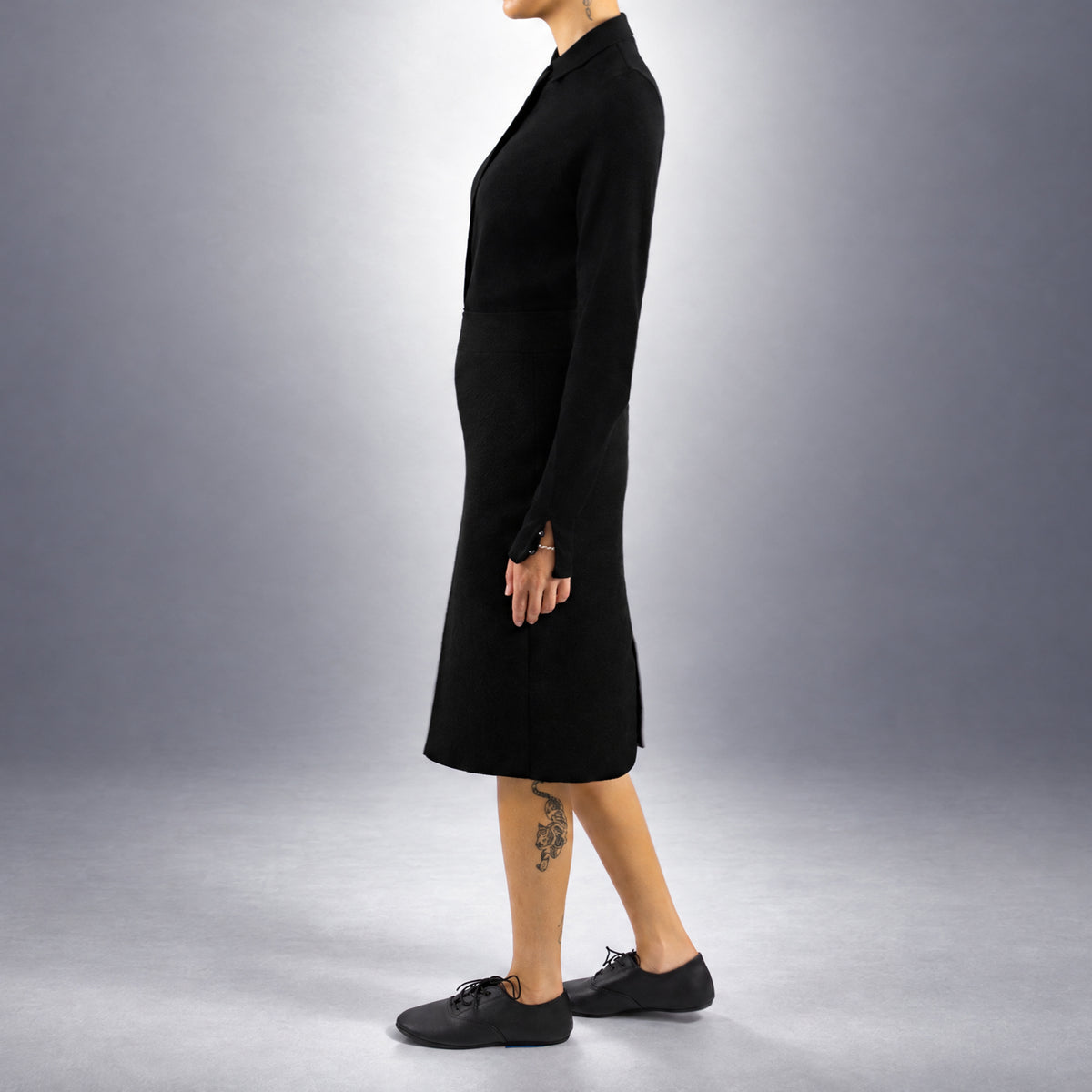 STANDISH. Mickey Skirt in Carbon Black, a knit skirt, worn, side view #color_carbon black