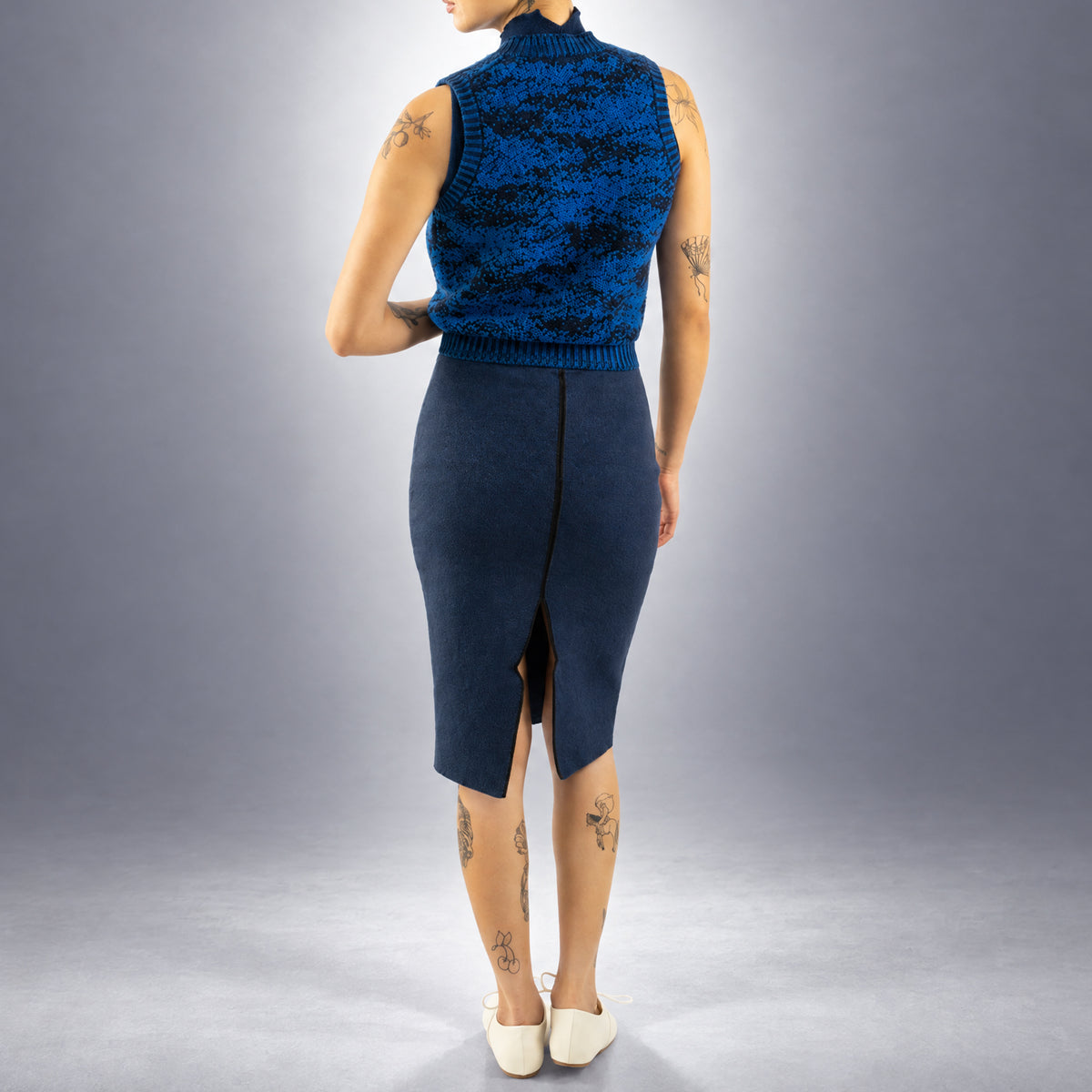 STANDISH. Paula Vest in Lapping Blue/Midnight Navy Jacquard, a knit vest, worn, back view #color_lapping blue/midnight navy jacquard