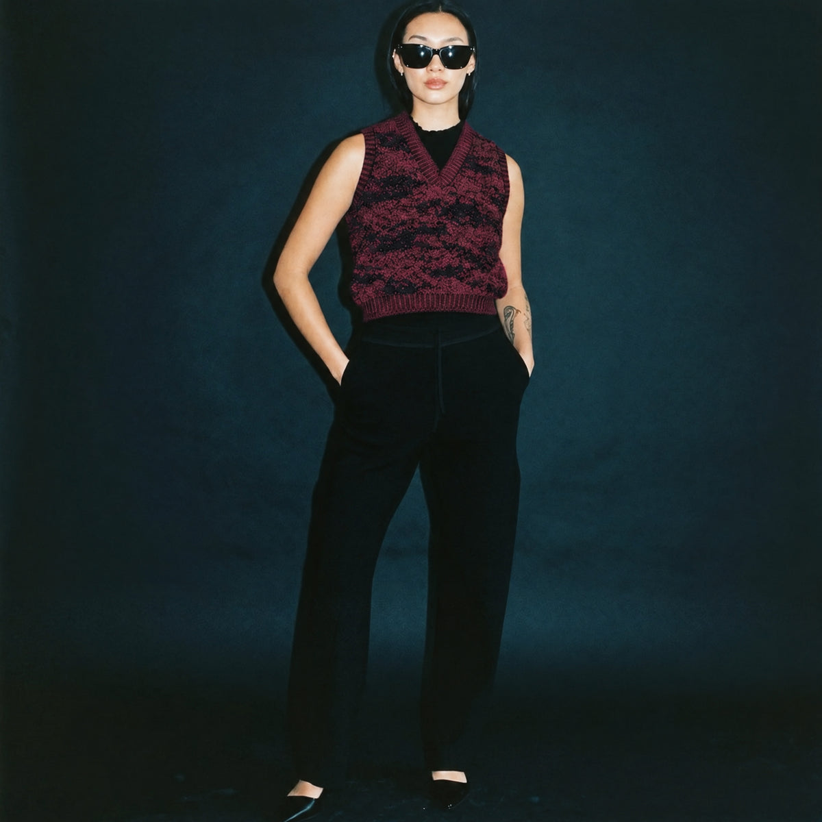 TANDISH. Suzy Track Pant in Carbon Black, a knit track pant, styled editorial shot #color_carbon black